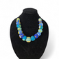 Necklace with blue and green beads on a black bust