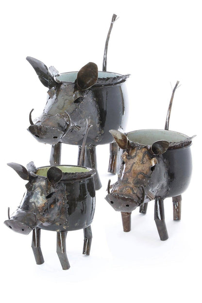 Three metal pig sculptures on a white background